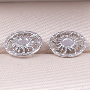Detail of silver sun totem hoop earrings in 304 stainless steel inside a jewelry box