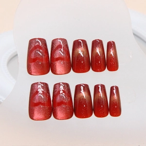 Sparkling cherry red cat eye press-on nails with heart patterns and coffin shape