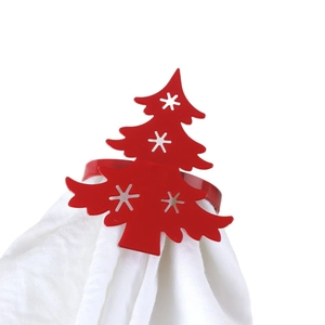 Red Christmas tree napkin ring with white snowflake cutouts on white fabric
