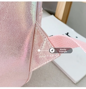 Detail of reinforced triangle stitching on holographic pink mermaid backpack strap