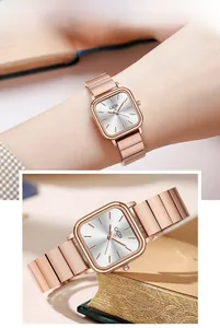 Detail of elegant rose gold square watch featuring a brushed metal strap and silver dial
