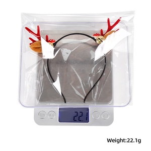 Detailed view of lightweight Christmas reindeer antler headband weighing 22.1g on a scale