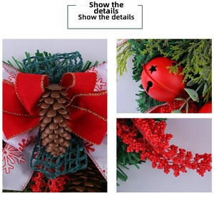 Close-up of Christmas wreath with red metal bell, pine cones and red berry clusters
