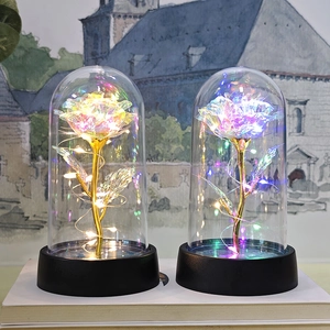 Luminous gold foil rose in glass dome with LED fairy lights on a black base