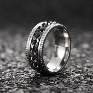 Macro shot of industrial retro rotatable chain ring with textured edges in silver