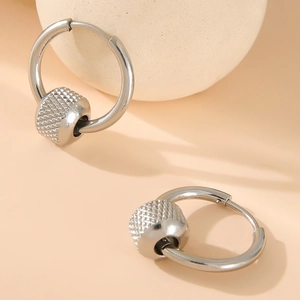 Silver stainless steel hoop earrings featuring cylindrical diamond-knurled texture beads