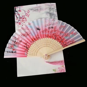 Detail of pink gradient Chinese folding fan with peach blossom ink art and pink tassel