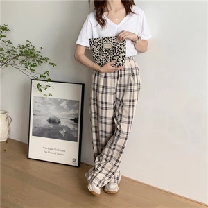 Chic lifestyle look with a leopard print canvas clutch paired with plaid wide-leg trousers