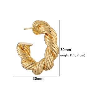 Detail of 30mm gold hollow C-shape earrings with twisted rope texture and high gloss finish