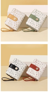 Close-up of four colorful short wallets with cute cat prints and secure zipper closure