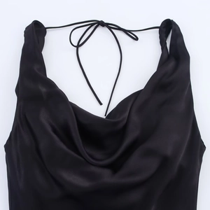 Detail of cowl neck and halter tie on elegant black satin dress with silk texture