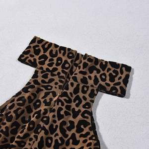 Detail of leopard print mesh jumpsuit showing neckline and back metal zipper closure