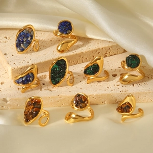 Detail of vintage gold stainless steel rings with blue, green, and brown natural stones