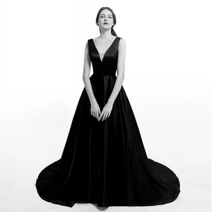 Detail of elegant V-neck satin evening gown with a high-waisted floor-length skirt