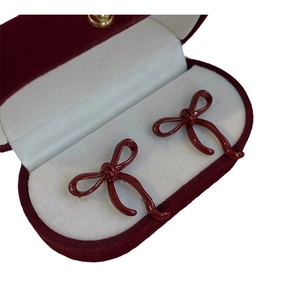 Chic dark red bow stud earrings in a luxury velvet jewelry box for a vintage style