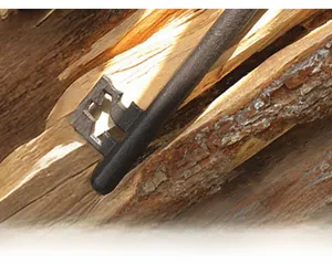 Macro detail of vintage cast iron key with textured finish on rustic wood background