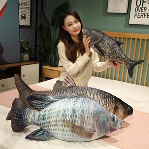 Three realistic plush fish pillows in various sizes showing detailed scales and fins
