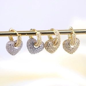 Close-up of heart-shaped copper earrings with micro-pave cubic zirconia settings