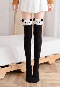 Detail of soft coral fleece over-knee socks with cute panda face and 3D ear accents