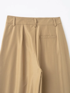 Detail of khaki twill trousers featuring the back waistband, belt loops and welt pocket