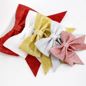Close-up of sparkling glitter bows in five festive colors for Christmas tree decorations