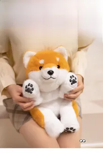 Close-up of a Shiba Inu plush toy featuring soft fur, black paw embroidery, and warm colors
