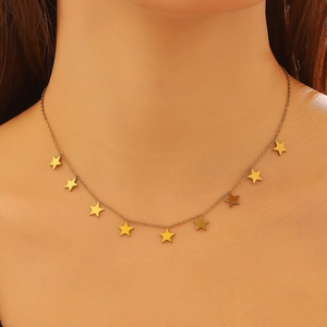 Close-up of a gold star charm choker necklace on a model showing fine chain links