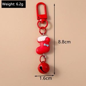 Close-up of a 6.2g Christmas stocking keychain with red bell and measurements