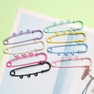 Flat lay of colorful 6cm metal safety pins in various candy colors for DIY accessories