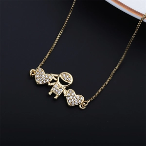 Detail of gold girl pendant with sparkling heart accents on black background