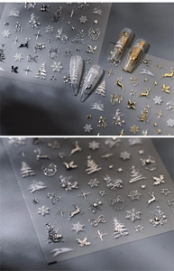 Detailed macro view of 3D embossed gold and silver Christmas nail art stickers with snowflakes