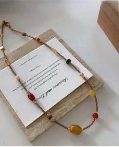 Close-up of Dunhuang style beaded necklace with natural agate and gold lobster clasp