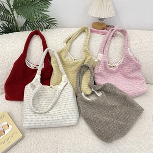 Detailed top view of colorful knit tote bags with magnetic metal buckle and soft lining