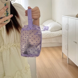 Detailed view of purple mesh makeup bag with flocked hearts showing storage capacity
