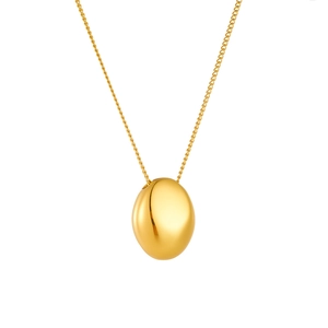 Polished gold bean pendant necklace with minimalist fine chain on white background