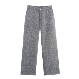 Detail of grey tweed trousers showing fine fabric texture and button closure
