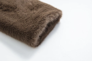 Macro detail of high-quality faux mink fur cuffs with professional stitching in deep brown
