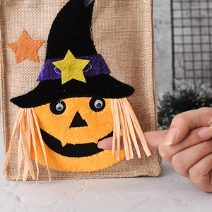 Detail of burlap Halloween candy bag with 3D pumpkin wizard and felt decorations