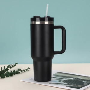40oz black stainless steel insulated tumbler with handle and straw in lifestyle setting
