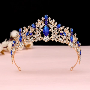 Macro detail of gold leaf tiara with sapphire blue marquise crystals and white rhinestones