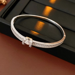 Detailed macro view of silver plated oval clasp bracelet with micro pave cubic zirconia
