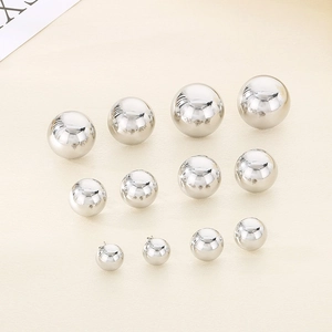 Detail showing six sizes of polished stainless steel silver ball stud earrings in rows
