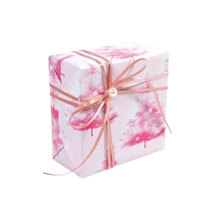 Pink Christmas gift wrapping paper with watercolor trees and rose gold ribbon