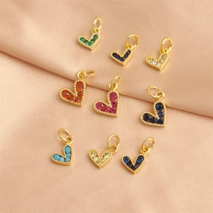 18K gold plated heart pendants with colorful zircon stones on pink silk fabric