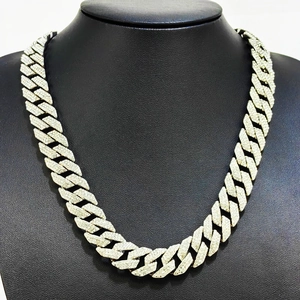 Detail of silver rhodium plated cuban link necklace with full diamond inlay on black bust