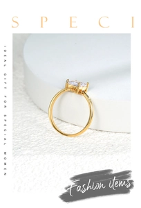 Detail of golden ring with a large clear square zircon stone on a white display stand