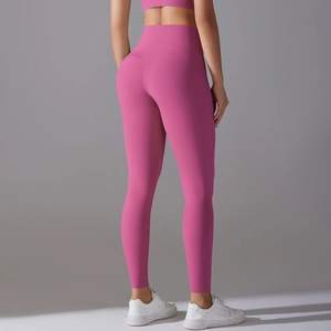 Detail view of pink high-waisted yoga leggings showing V-seam peach lift design