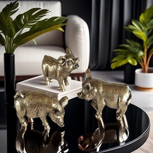 Detailed macro view of three vintage bronze pig figurines on a modern tabletop display