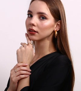 Detail of 18K gold plated ring featuring asymmetric star and water drop zircon stones
