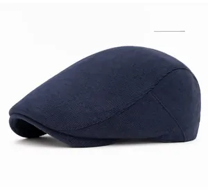 Detail of navy blue corduroy newsboy cap showing fine ribbed texture and sturdy brim